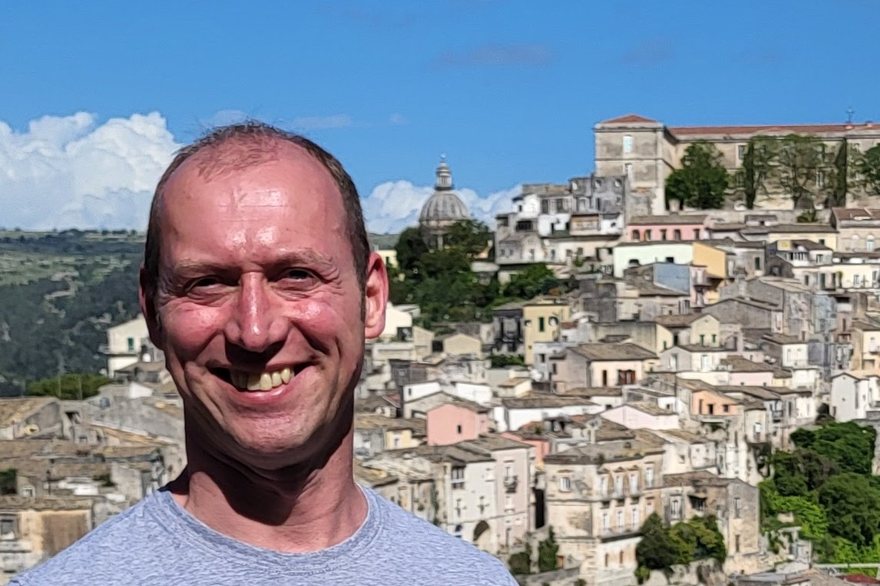 Dom Hebblethwaite in front of Ragusa Ibla, the Duomo dome on the skyline behind