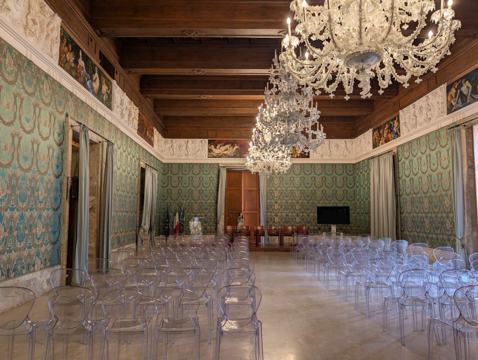 The Salone Paolo Borsellino in Palazzo Vermexio, chairs set out for a ceremony under glass chandeliers and a coffered wooden ceiling